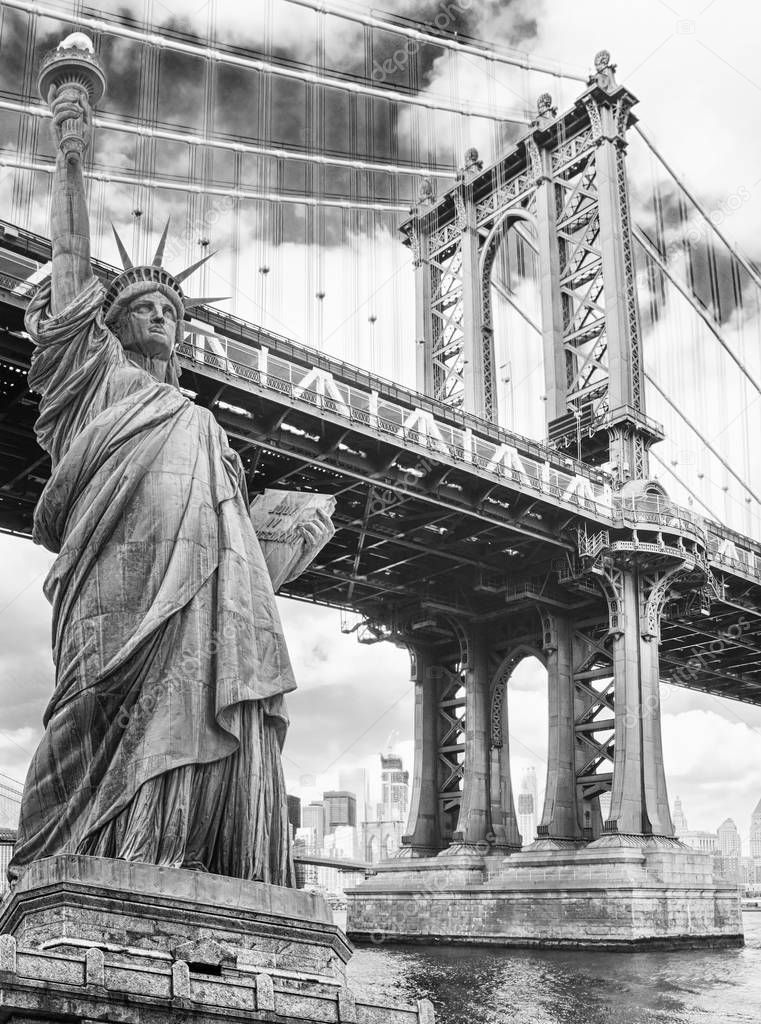 Statue of Liberty against Manhattan Bridge, New York, USA