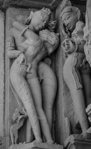 Stone carved erotic bas relief in Hindu temple in Khajuraho, India. Unesco World Heritage Site