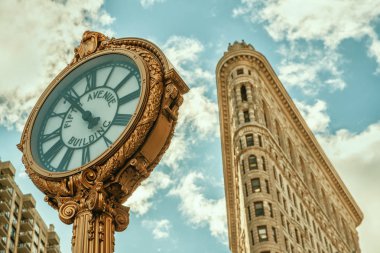New York City, USA - November 29, 2018: Fifth Avenue Clock with the Flatiron Building clipart