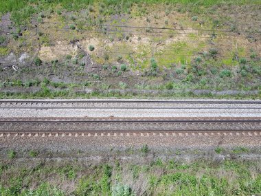 Çimlerin ve çalıların arasında demiryolu