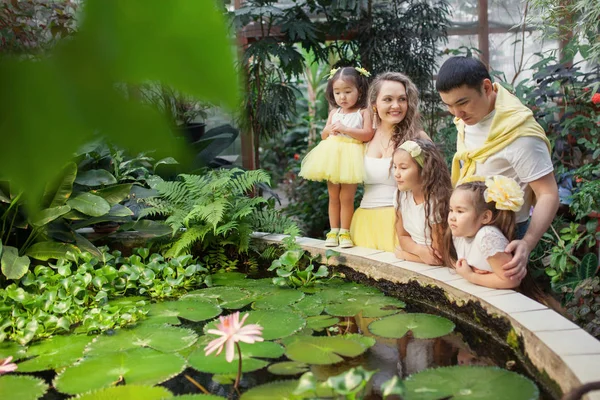 Glada Systrar Och Föräldrar Promenad Botaniska Trädgården Flickor Gula Kjolar — Stockfoto