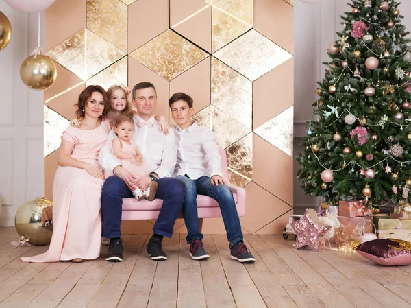 Portrait of beautiful big happy family at window in Christmas decorations, indoor
