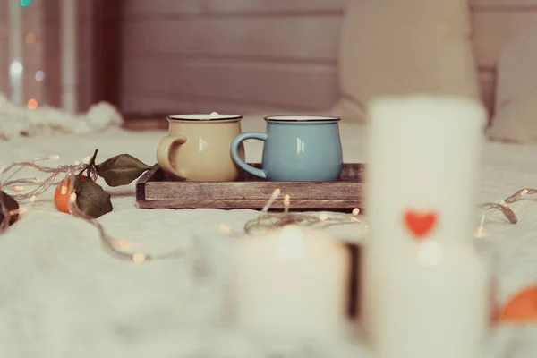 two mugs on wooden stand, comfort and warm mood