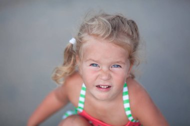 Küçük şirin mutlu kız oynar ve İspanya denizde yüzüyor