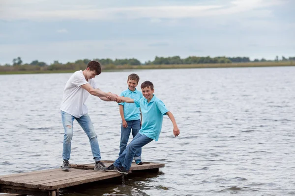 Group of happy cheerful beautiful children play near lake, outdoor — Stock Photo, Image