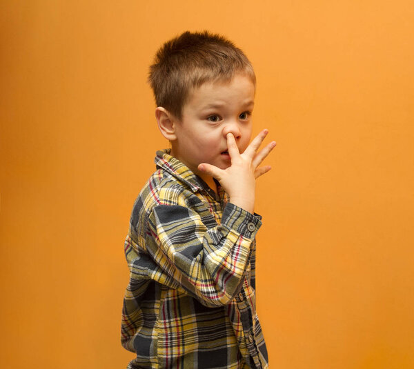 Little boy picking his nose. Funny picture of boy. Bad habit concept