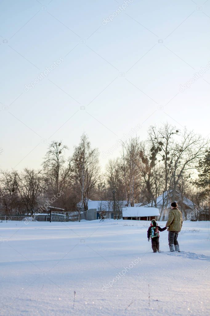 Boy and grandfather enjoying the snow. Happy boy grandpa have winter fun