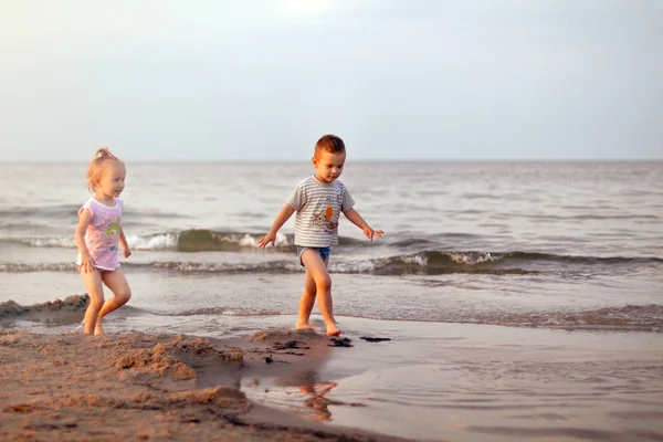 Happy family brother and sister playing on the beach — Stock Photo, Image