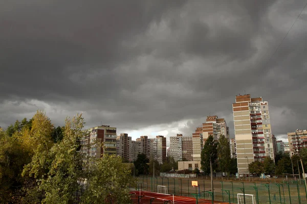 Městská krajina s tmavou bouřkovou oblohou — Stock fotografie