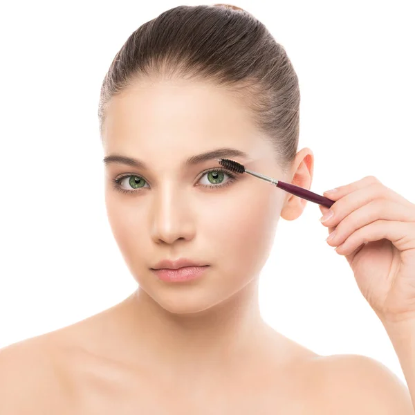 Young brunette woman with clean face. Girl perfect skin applying cosmetic brush. Isolated on white. — Stock Photo, Image