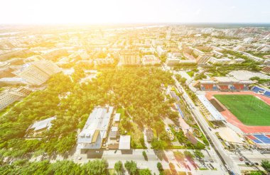 Kesişen yollar, evler, binalar, parklar ve otoparklar olan havacılık şehri manzarası. Güneşli yaz panoramik resmi