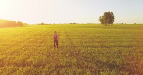 Low altitude drone flight in front of sporty woman at perfect asphalt road — Stock Video