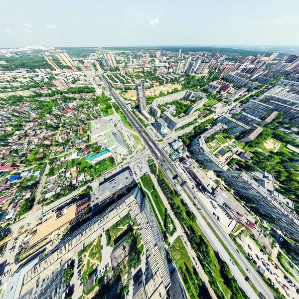 Vista aérea de la ciudad con encrucijadas y caminos, casas, edificios, parques y estacionamientos. Imagen panorámica soleada de verano — Foto de Stock