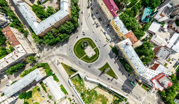 Aerial city view with crossroads and roads, houses, buildings, parks and parking lots. Sunny summer panoramic image — Stock Photo, Image