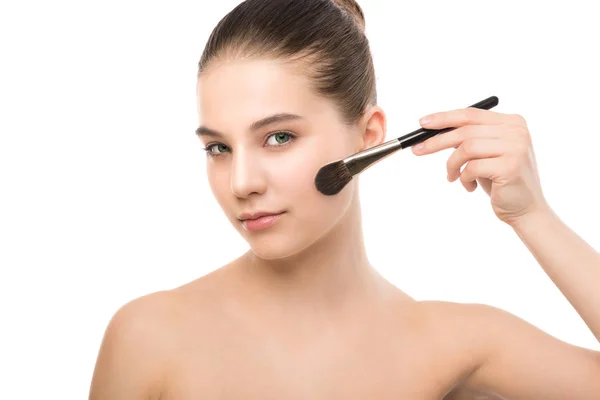 Young brunette woman with clean face. Girl perfect skin applying cosmetic brush. Isolated on a white. — Stock Photo, Image