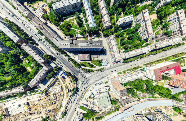 Aerial city view with crossroads and roads, houses, buildings, parks and parking lots, bridges. Helicopter drone shot. Wide Panoramic image.