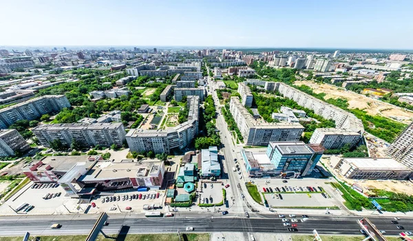 Aerial city view with crossroads and roads, houses, buildings, parks and parking lots. Sunny summer panoramic image — Stock Photo, Image