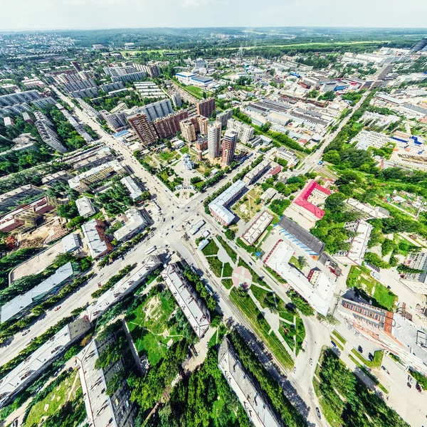 Aerial city view with crossroads and roads, houses, buildings, parks and parking lots. Sunny summer panoramic image — Stock Photo, Image