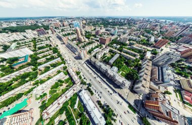 Kesişen yollar, evler, binalar, parklar ve otoparklar olan havacılık şehri manzarası. Güneşli yaz panoramik resmi