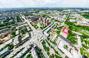 Kesişen yollar, evler, binalar, parklar ve otoparklar olan havacılık şehri manzarası. Güneşli yaz panoramik resmi