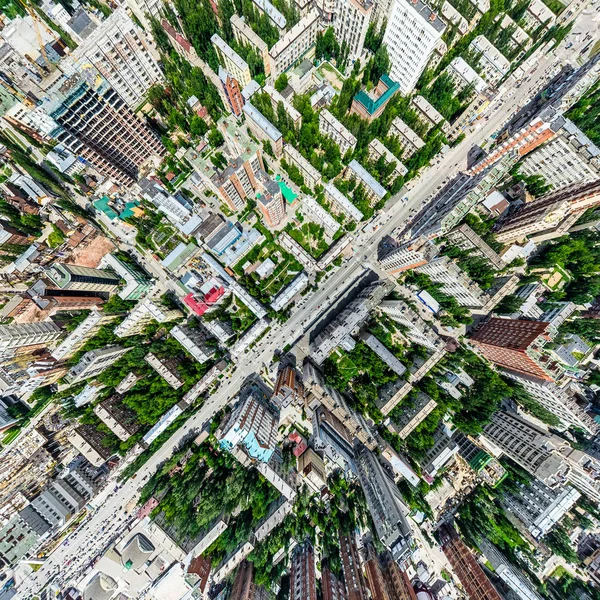 Aerial city view with crossroads and roads, houses, buildings, parks and parking lots. Sunny summer panoramic image — Stock Photo, Image