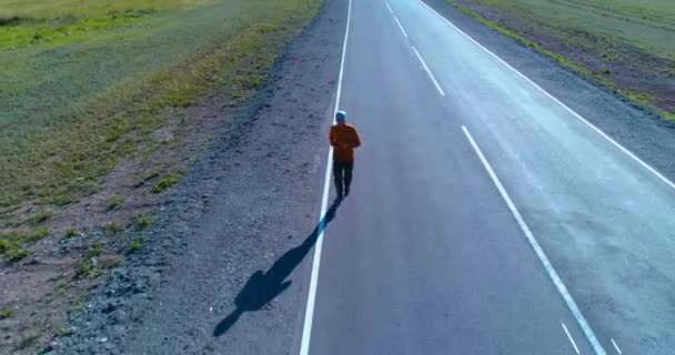 Низкая высота полета перед спортивным человеком на идеальной асфальтовой дороге — стоковое видео