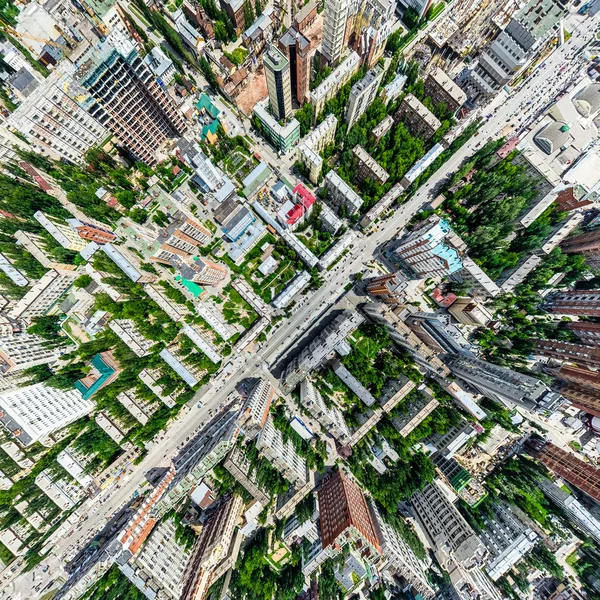 Aerial city view with crossroads and roads, houses, buildings, parks and parking lots. Sunny summer panoramic image — Stock Photo, Image