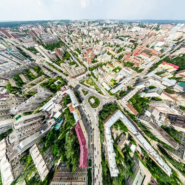 Vista aérea de la ciudad con encrucijadas y caminos, casas, edificios, parques y estacionamientos. Imagen panorámica soleada de verano —  Fotos de Stock