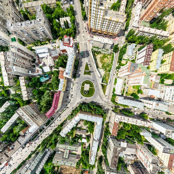 Aerial city view with crossroads and roads, houses, buildings, parks and parking lots. Sunny summer panoramic image — Stock Photo, Image