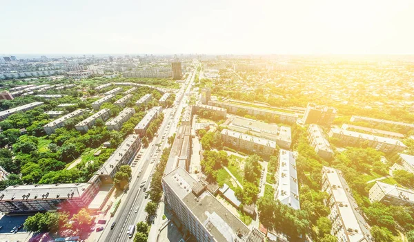 Vista aérea de la ciudad con encrucijadas y caminos, casas, edificios, parques y estacionamientos. Imagen panorámica soleada de verano — Foto de Stock