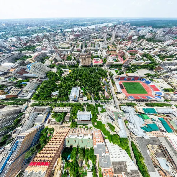 Vista aérea de la ciudad con encrucijadas y caminos, casas, edificios, parques y estacionamientos. Imagen panorámica soleada de verano —  Fotos de Stock