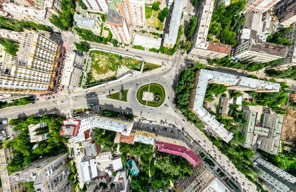 Aerial city view with crossroads and roads, houses, buildings, parks and parking lots. Sunny summer panoramic image — Stock Photo, Image