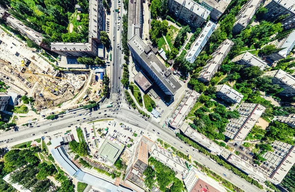 Aerial city view with crossroads and roads, houses, buildings, parks and parking lots. Sunny summer panoramic image — Stock Photo, Image