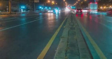 Sokak kavşağında gece trafiğinin aşırı hızlanması. Arabaların ve motorsikletlerin hareket zamanı.