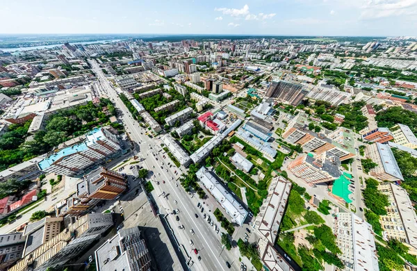 Aerial city view with crossroads and roads, houses, buildings, parks and parking lots. Sunny summer panoramic image — Stock Photo, Image