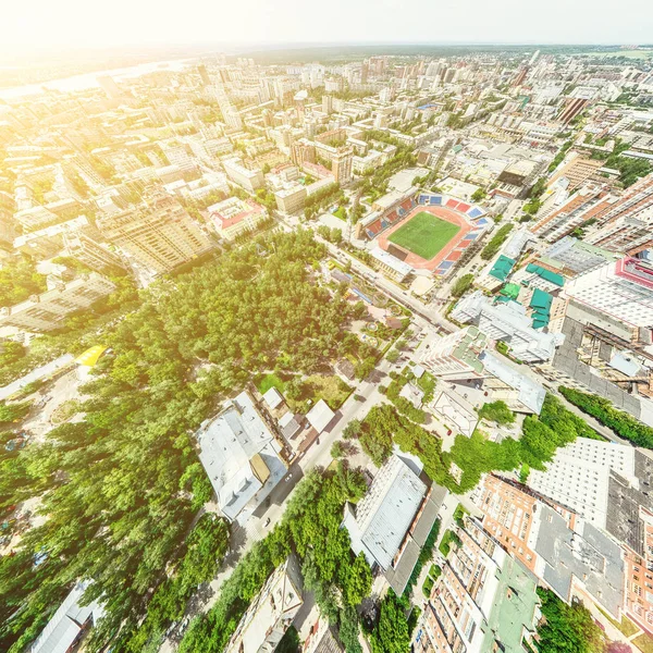 Aerial city view with crossroads and roads, houses, buildings, parks and parking lots. Sunny summer panoramic image — Stock Photo, Image