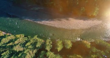 Güneşli yaz sabahında kayalarla birlikte taze, hızlı dağ nehri üzerinde alçak irtifa uçuşu..
