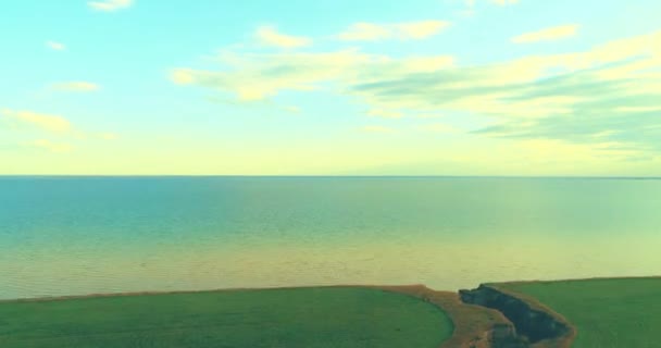 Aerial hyperlapse of sunset and clouds above sea coast. Timelapse drone fly near ocean bank. High speed horizontal moving. — Stock Video