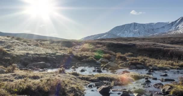 Mountain meadow timelapse at the summer or autumn time. Wild nature and rural valley. Sun rays, small creek and yellow grass. Dolly slider movement — Stock Video