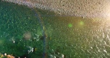 Güneşli yaz sabahında kayalarla birlikte taze, hızlı dağ nehri üzerinde alçak irtifa uçuşu..