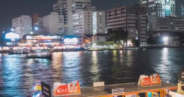 Timelapse of harbour maharaj and ferry area on Chao Phraya River. Night illumination at Bangkok, Asia, Thailand, NOV 22, 2018 — Stock Video