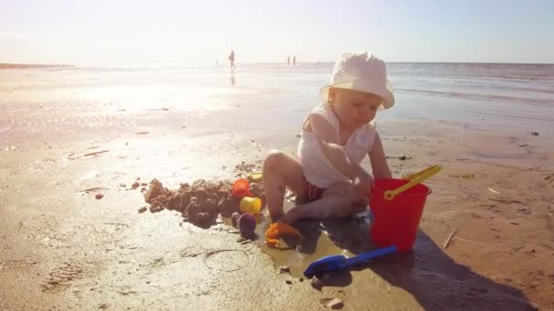 Παιδί Στην Παραλία Παίζει Την Άμμο Και Παιχνίδια — Αρχείο Βίντεο