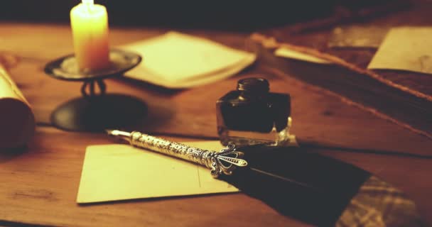 writing letter with quill pen and ink in candlelight