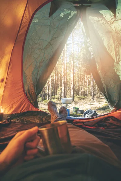 Wanderlust - man relaxing in tent after hike with cup of tea — Stock Photo, Image