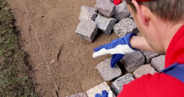 Cobblestone Paving Worker Installing Granite Stone Pavers — Stock Video