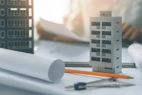 Apartment building scale models and blueprints on the table in a — Stock Photo, Image