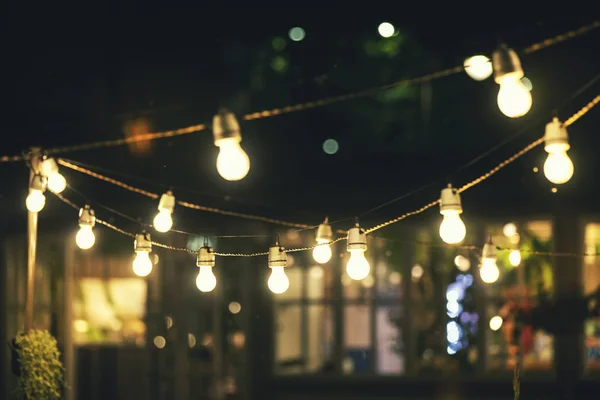 Outdoor party string lights glowing at night — Stock Photo, Image