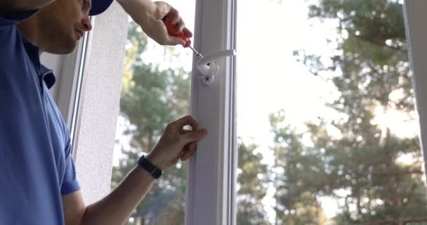Window service worker installing handle on plastic frame — Stock Footage Window Service Worker Installing Handle Plastic Frame Royalty Free Stock Footage