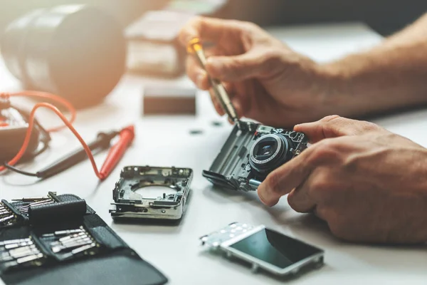 electronic repair service - technician repairing digital camera