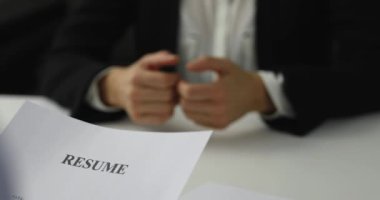 hiring manager interviews a woman in a job interview reviewing resume